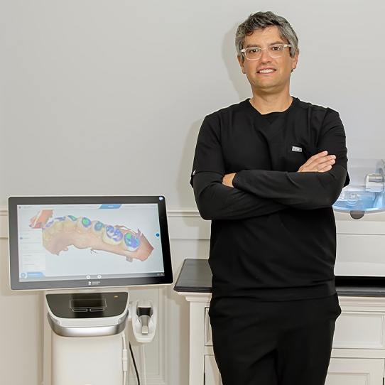 Doctor Graber standing next to CEREC system