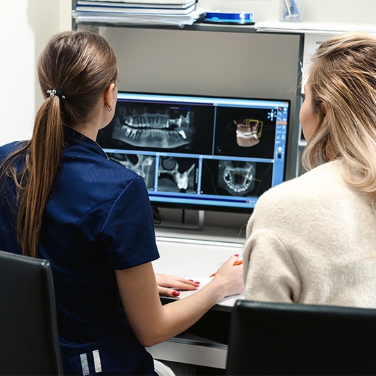 Patient and dental team member looking at digital smile impressions