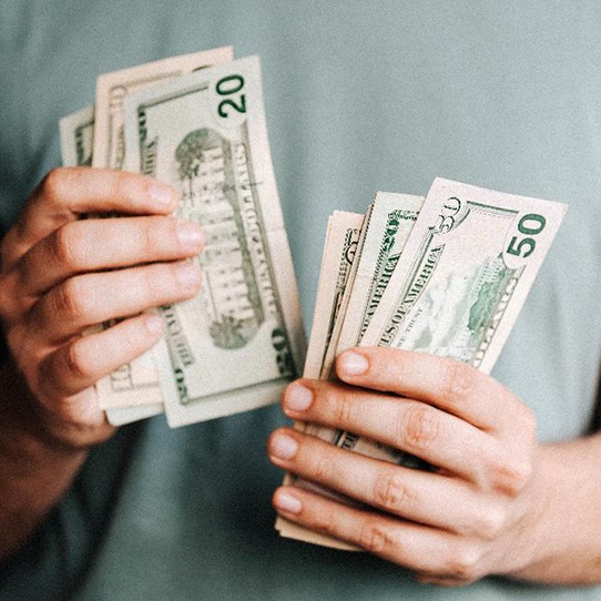 Close up of male’s hands counting cash