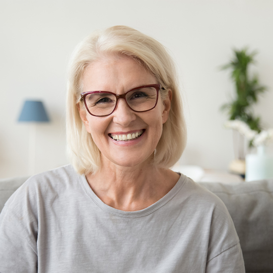 Woman sharing beautiful smile after dental crown restoration