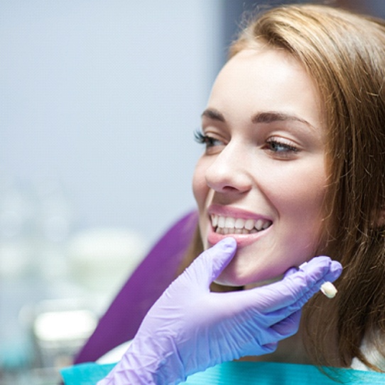 Woman with dental crowns in Shelton visiting her dentist