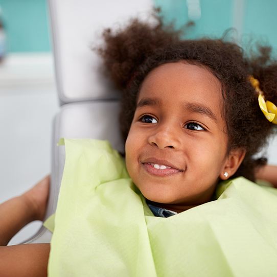 Smiling young girl in office for preventive dentistry checkup