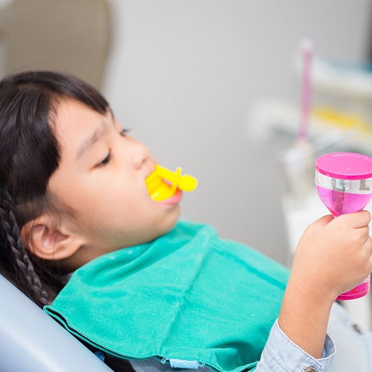 Child receiving silver diamine fluoride treatment