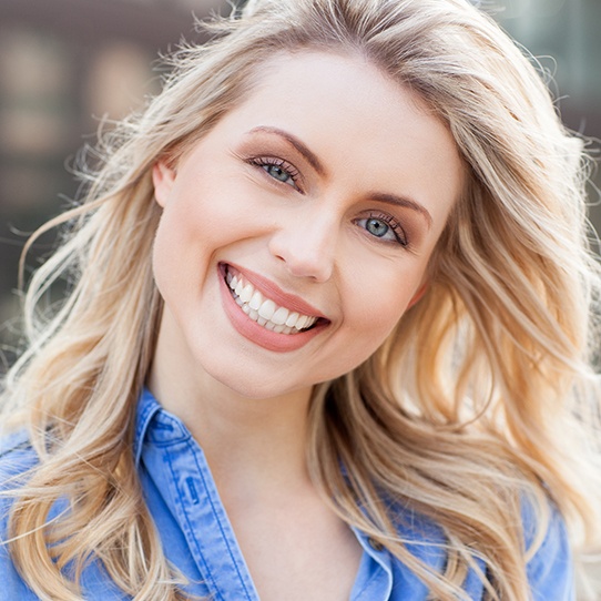 Woman with porcelain veneers smiling