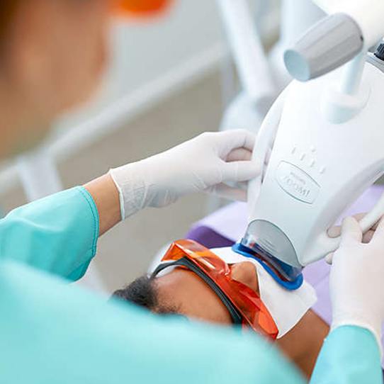 Man receiving teeth whitening treatment