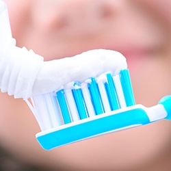 toothpaste and toothbrush for oral hygiene to maintain dental implants