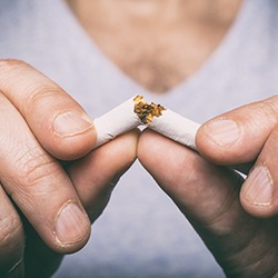 person breaking a bad habit of smoking for dental implants