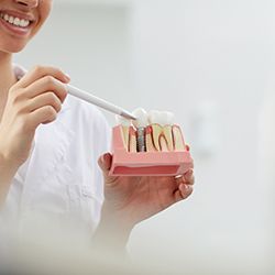 Dentist showing patient different parts of implant