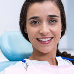 a patient smiling during her dental implant surgery appointment