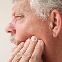 a patient experiencing minor pain after dental implant surgery