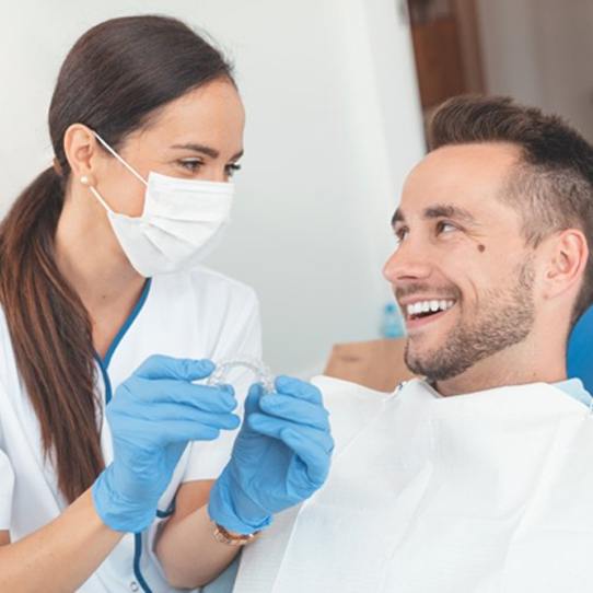 Dentist and patient discussing Invisalign