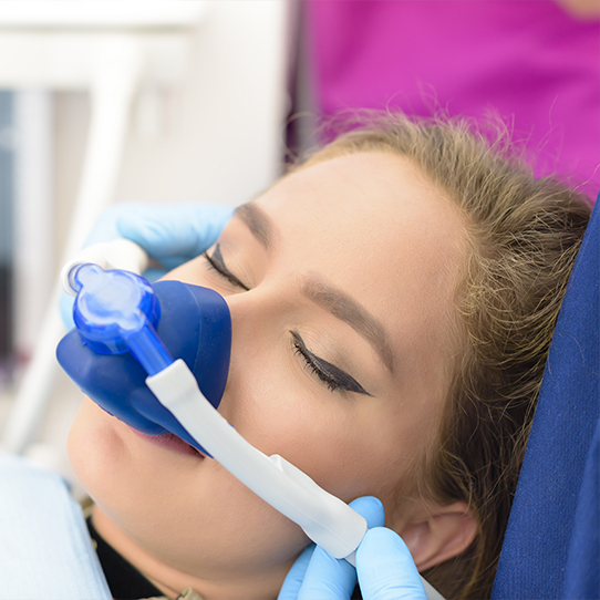 Woman with nitrous oxide dental sedation mask