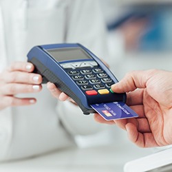 Patient using credit card to pay for SureSmile treatment