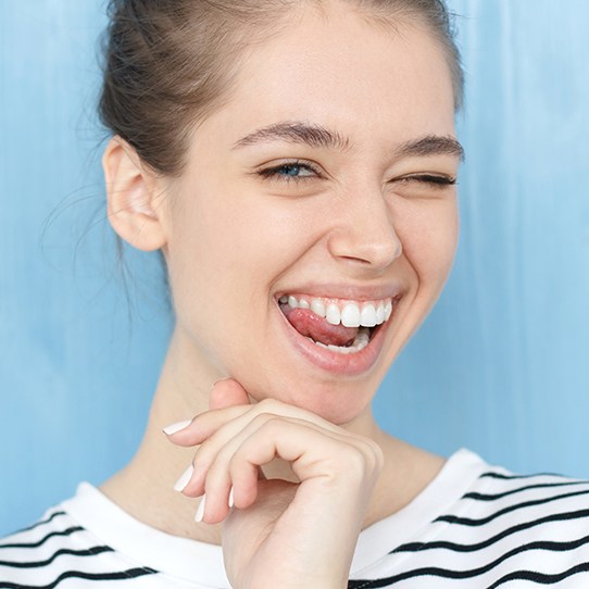 Woman showing off smile after receiving porcelain veneers