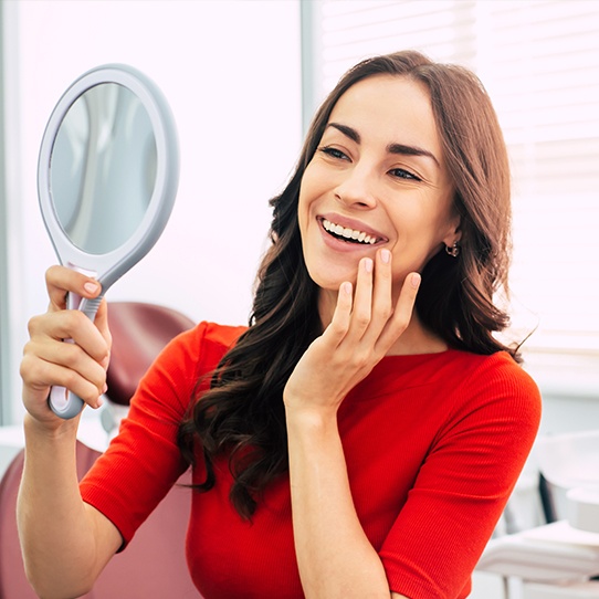 Woman looking at smile after teeth whitening