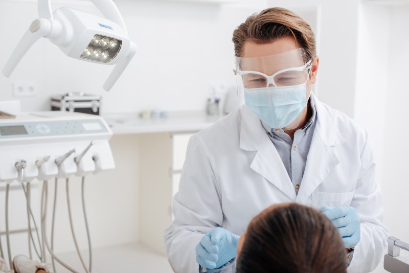 Dentist in Shelton wearing PPE during appointment  