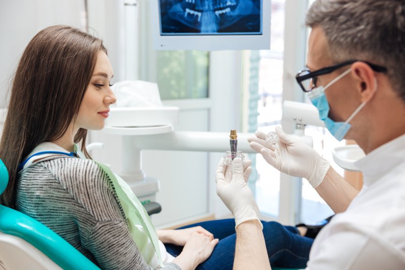 A dentist explaining how dental implants are safe